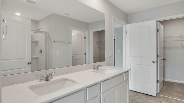 4028 Roane Dr, White House, TN 37188 - full bath with a walk in closet, double vanity, and an enclosed shower