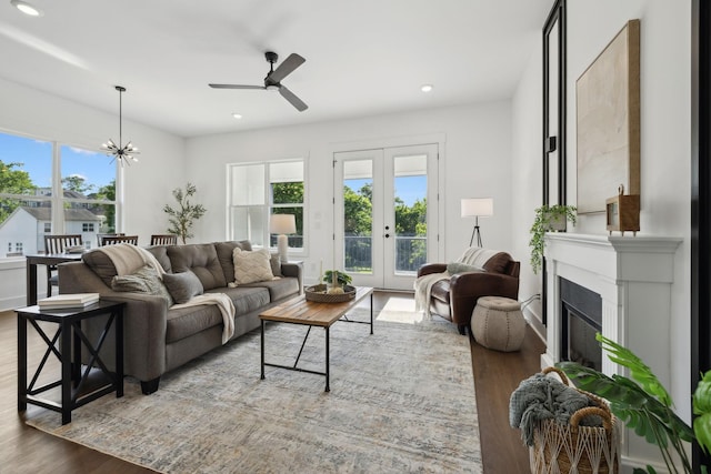 2211 18th Ave N, Nashville, TN 37208 - living room featuring wood finished floors, ceiling fan, a chandelier, french doors, and a glass covered fireplace