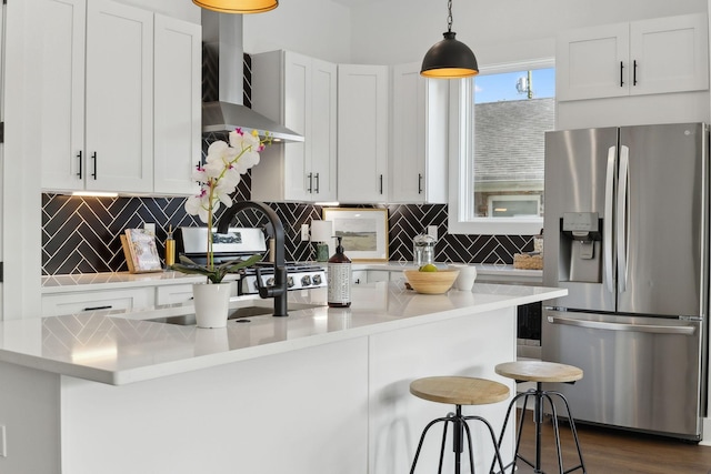 2211 18th Ave N, Nashville, TN 37208 - kitchen featuring stainless steel refrigerator with ice dispenser, wall chimney range hood, decorative backsplash, and light countertops