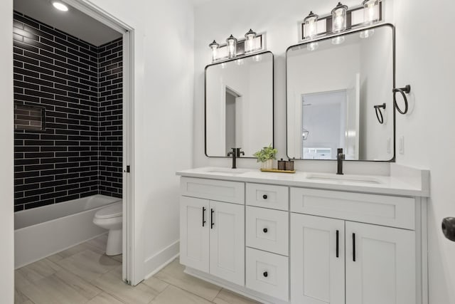 2211 18th Ave N, Nashville, TN 37208 - full bathroom featuring toilet, double vanity, and baseboards