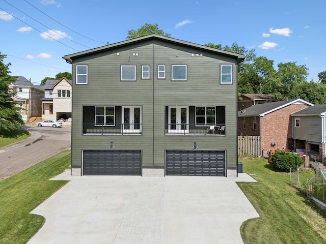 2211 18th Ave N, Nashville, TN 37208 - view of front of house featuring driveway, a garage, and a front lawn