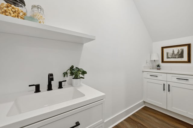 2211 18th Ave N, Nashville, TN 37208 - bathroom featuring vanity, vaulted ceiling, and wood finished floors