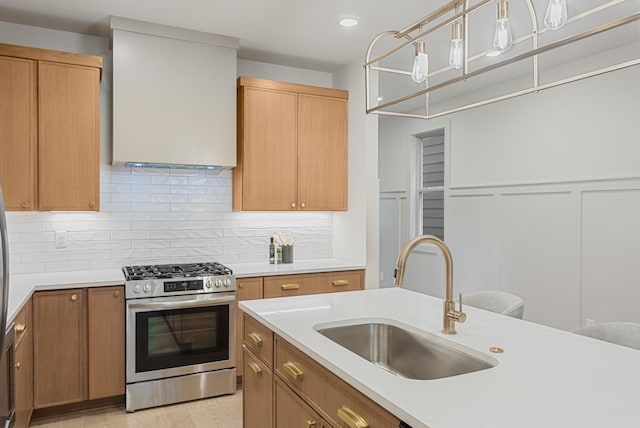 301B Oriel Ave, Nashville, TN 37210 - kitchen with stainless steel range with gas stovetop, a sink, wall chimney exhaust hood, light countertops, and tasteful backsplash