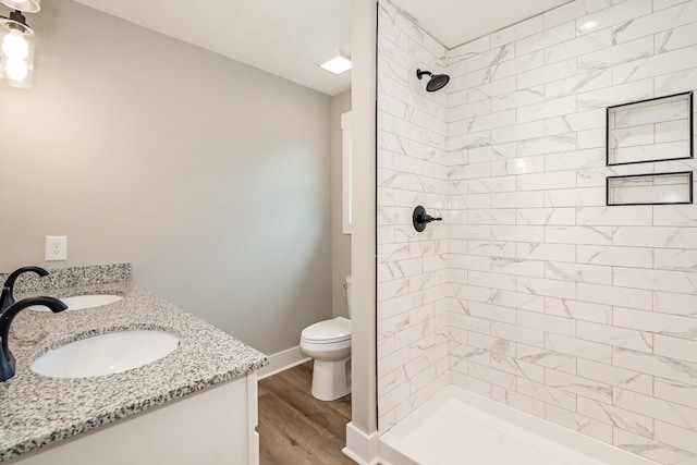 1515 Ellie Claire Way, Lewisburg, TN 37091 - bathroom with tiled shower, toilet, wood finished floors, double vanity, and baseboards