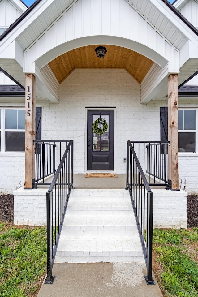 1515 Ellie Claire Way, Lewisburg, TN 37091 - doorway to property featuring covered porch, brick siding, and board and batten siding