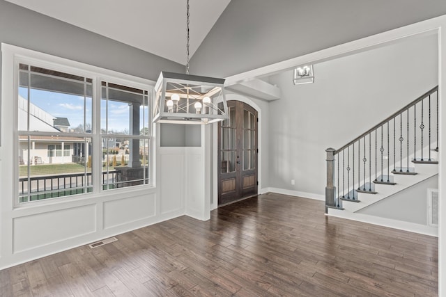 512 River Watch Way, Winchester, TN 37398 - unfurnished dining area featuring a chandelier, wood finished floors, a decorative wall, stairway, and high vaulted ceiling