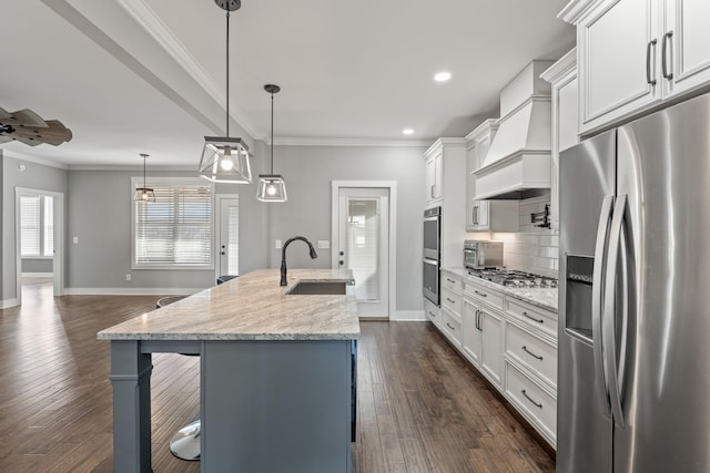 512 River Watch Way, Winchester, TN 37398 - kitchen featuring appliances with stainless steel finishes, a sink, premium range hood, a kitchen breakfast bar, and baseboards
