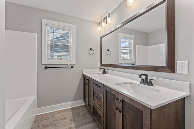 512 River Watch Way, Winchester, TN 37398 - bathroom featuring wood finished floors, baseboards, double vanity, a bath, and a shower