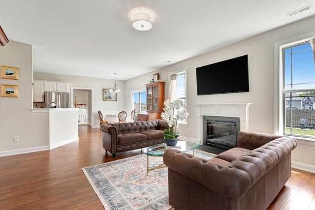 1003 Garrison Way, Spring Hill, TN 37174 - living area with wood finished floors, baseboards, a glass covered fireplace, and a chandelier