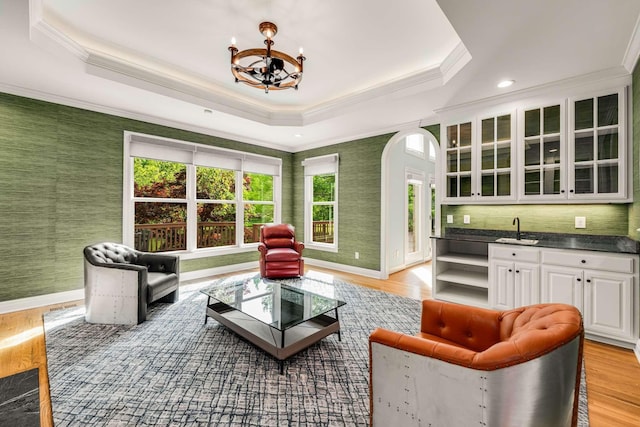316 Whitworth Way, Nashville, TN 37205 - living room featuring crown molding, arched walkways, a tray ceiling, baseboards, and a chandelier
