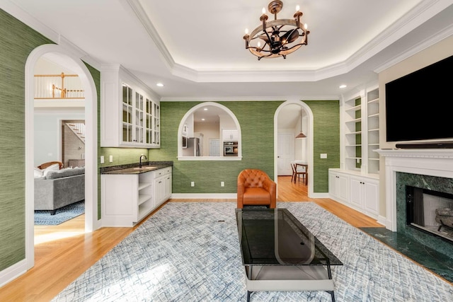 316 Whitworth Way, Nashville, TN 37205 - kitchen featuring a sink, light wood finished floors, white cabinets, a high end fireplace, and a chandelier
