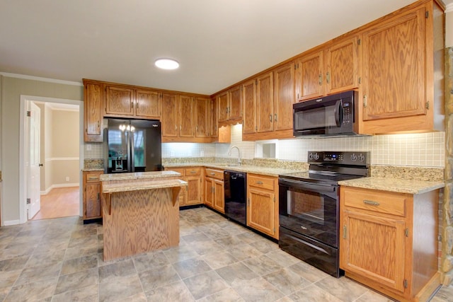 339 Thompson Ln, Clarksville, TN 37040 - kitchen with black appliances, a sink, backsplash, a kitchen island, and baseboards