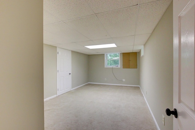 339 Thompson Ln, Clarksville, TN 37040 - below grade area featuring light carpet, a paneled ceiling, and baseboards
