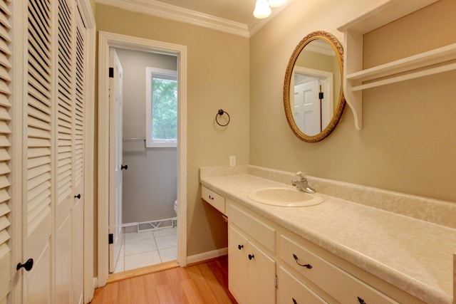 339 Thompson Ln, Clarksville, TN 37040 - bathroom featuring vanity, toilet, ornamental molding, a closet, and wood finished floors