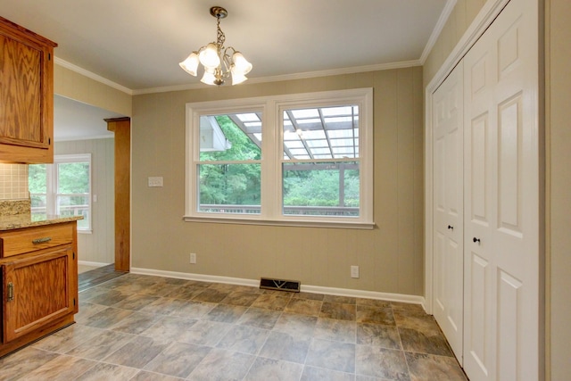 339 Thompson Ln, Clarksville, TN 37040 - unfurnished dining area with a chandelier, baseboards, stone finish flooring, and ornamental molding