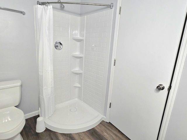 118 Bone Cave Rd, Rock Island, TN 38581 - full bathroom featuring wood finished floors, toilet, a shower stall, and baseboards
