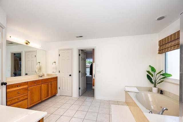 909 Miranda Pl, Franklin, TN 37067 - bathroom featuring tile patterned flooring, a tub with jets, vanity, a closet, and baseboards