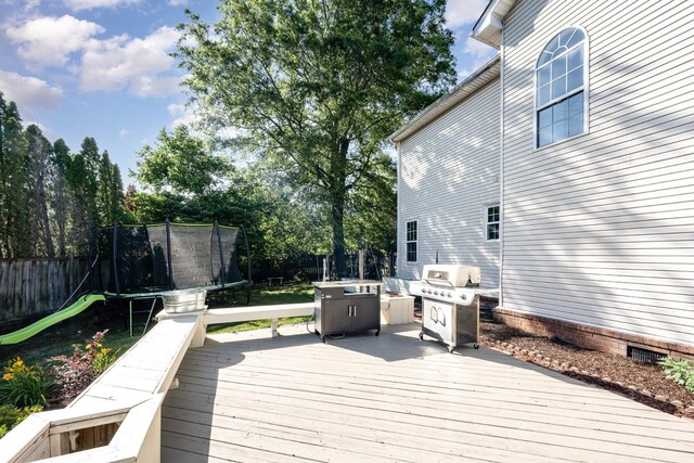 909 Miranda Pl, Franklin, TN 37067 - wooden deck featuring a trampoline, grilling area, and fence