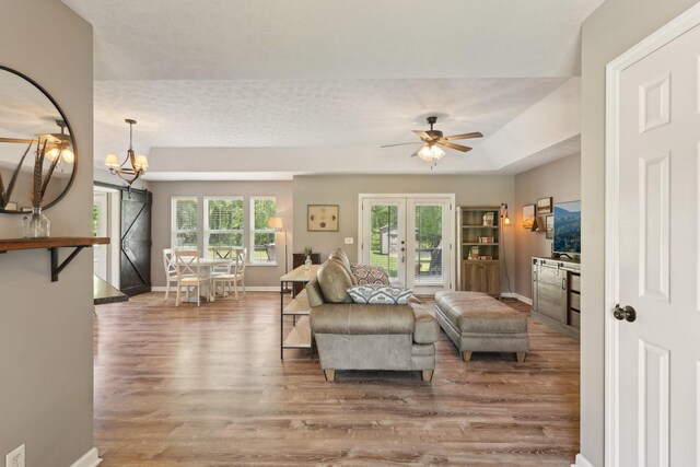 2277 Belotes Ferry Rd, Lebanon, TN 37087 - living room featuring wood finished floors, baseboards, ceiling fan, and a chandelier