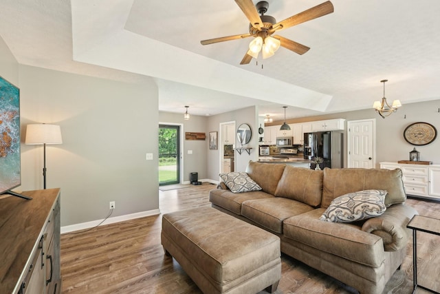 2277 Belotes Ferry Rd, Lebanon, TN 37087 - living area with wood finished floors, baseboards, a ceiling fan, and a chandelier