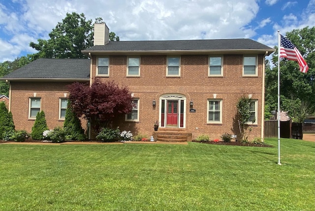 415 Ashley Ln, Kingston Springs, TN 37082 - colonial home with entry steps, a chimney, a front yard, and brick siding