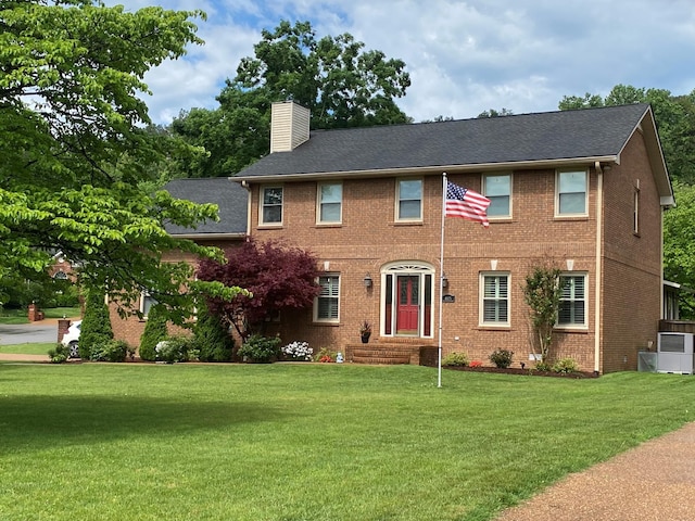 415 Ashley Ln, Kingston Springs, TN 37082 - colonial home featuring a chimney, a front yard, and brick siding