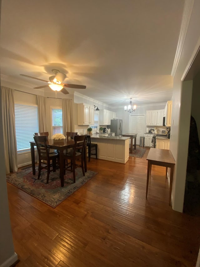415 Ashley Ln, Kingston Springs, TN 37082 - dining area featuring a chandelier, crown molding, dark wood-type flooring, and ceiling fan