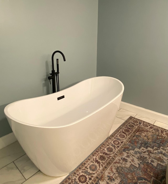 415 Ashley Ln, Kingston Springs, TN 37082 - full bathroom with marble look tile flooring and a freestanding bath