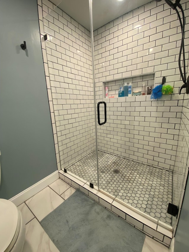 415 Ashley Ln, Kingston Springs, TN 37082 - bathroom with a shower stall and marble look tiles