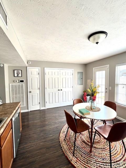 1011 Wolves Den Pl, Murfreesboro, TN 37128 - dining area featuring a textured ceiling, dark wood-type flooring, baseboards, and electric panel