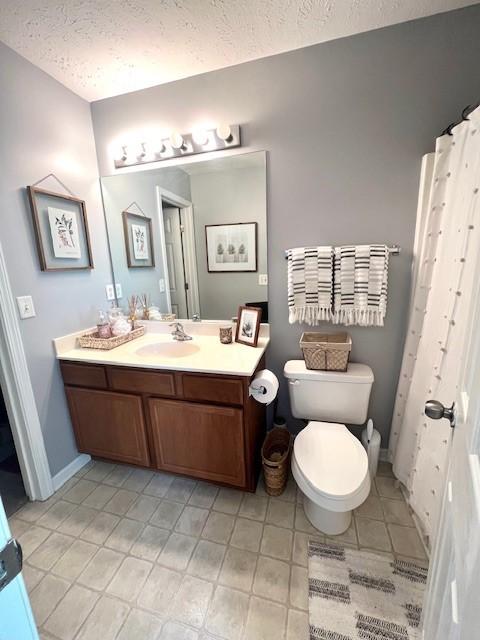 1011 Wolves Den Pl, Murfreesboro, TN 37128 - bathroom with vanity, a textured ceiling, toilet, baseboards, and tile patterned floors