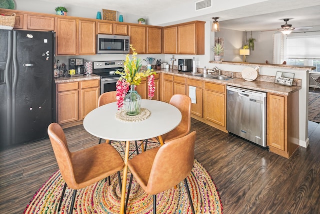 1011 Wolves Den Pl, Murfreesboro, TN 37128 - kitchen featuring appliances with stainless steel finishes, a peninsula, dark wood finished floors, a ceiling fan, and light countertops