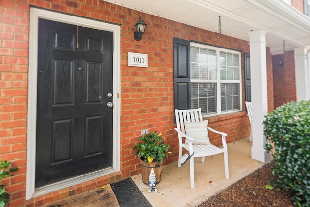 1011 Wolves Den Pl, Murfreesboro, TN 37128 - doorway to property with brick siding and a porch