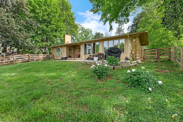 209 Woods Dr, Columbia, TN 38401 - rear view of house with a chimney and a patio area