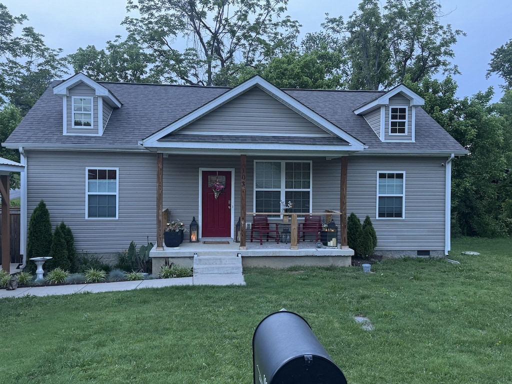 103 Lockhart St, Dickson, TN 37055 - view of front of house with covered porch, a front yard, and a shingled roof