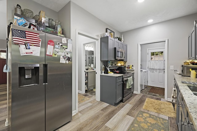 103 Lockhart St, Dickson, TN 37055 - kitchen featuring stainless steel appliances, washing machine and dryer, wood finished floors, gray cabinets, and recessed lighting
