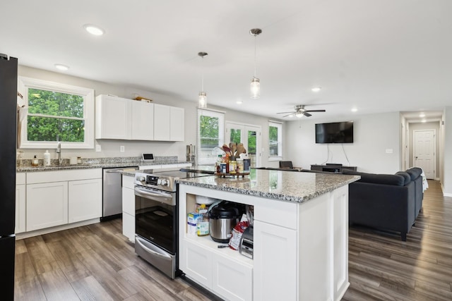 176 Morningside Dr, La Vergne, TN 37086 - kitchen featuring appliances with stainless steel finishes, a sink, recessed lighting, white cabinetry, and light stone countertops