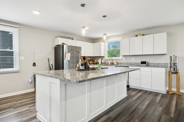176 Morningside Dr, La Vergne, TN 37086 - kitchen with freestanding refrigerator, white cabinetry, dark wood finished floors, baseboards, and a kitchen island
