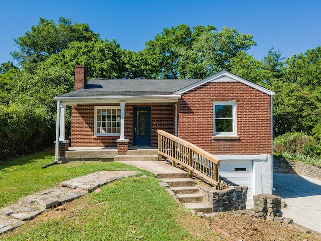 512 Transit Ave, Columbia, TN 38401 - view of front of property featuring a chimney, a garage, brick siding, and covered porch