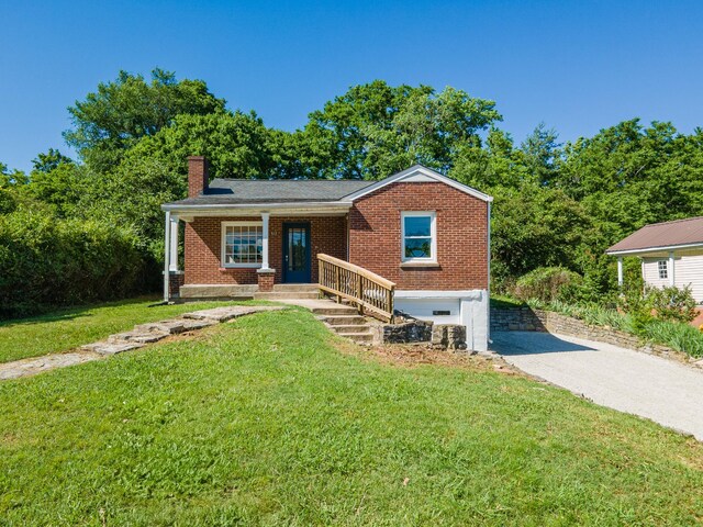 512 Transit Ave, Columbia, TN 38401 - view of front of home with a chimney, a front yard, and brick siding