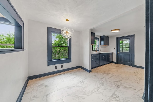 512 Transit Ave, Columbia, TN 38401 - unfurnished dining area featuring a sink, baseboards, light marble finish floors, and a chandelier