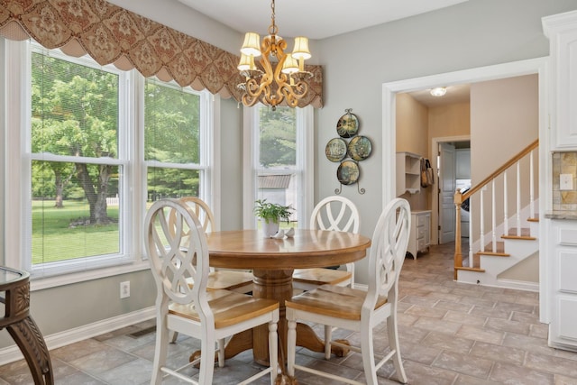2305 Black Fox Ct, Murfreesboro, TN 37127 - dining space with healthy amount of natural light, a chandelier, stone finish flooring, and stairway
