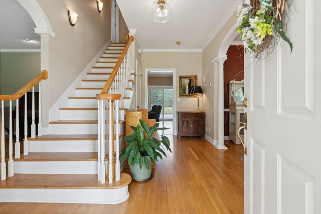2305 Black Fox Ct, Murfreesboro, TN 37127 - entryway with arched walkways, hardwood / wood-style floors, crown molding, stairway, and ornate columns