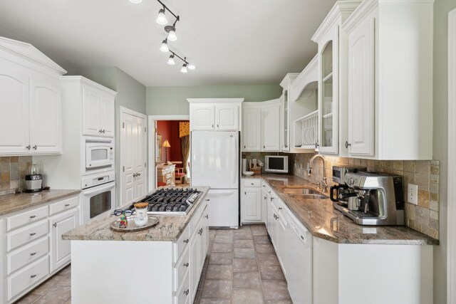 2305 Black Fox Ct, Murfreesboro, TN 37127 - kitchen with white appliances, a sink, decorative backsplash, and light stone counters