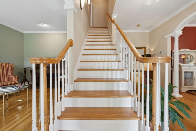 2305 Black Fox Ct, Murfreesboro, TN 37127 - stairway with decorative columns, crown molding, arched walkways, and wood finished floors