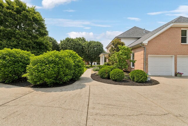 2305 Black Fox Ct, Murfreesboro, TN 37127 - view of home's exterior with brick siding, driveway, a garage, and roof with shingles