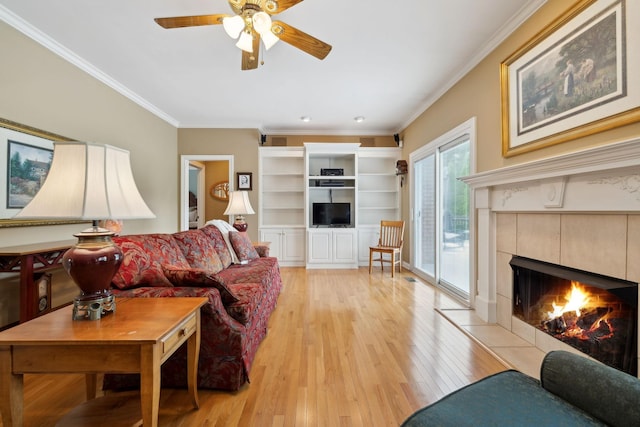 2305 Black Fox Ct, Murfreesboro, TN 37127 - living room with ornamental molding, light wood-style flooring, a tile fireplace, and ceiling fan