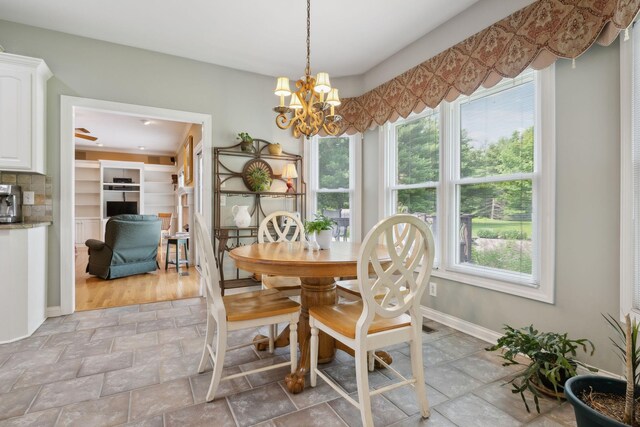 2305 Black Fox Ct, Murfreesboro, TN 37127 - dining space featuring plenty of natural light, light stone finish flooring, baseboards, and a chandelier