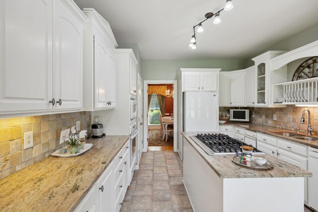 2305 Black Fox Ct, Murfreesboro, TN 37127 - kitchen featuring a sink, white appliances, white cabinets, backsplash, and light stone countertops