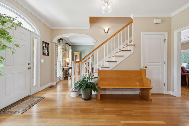 2305 Black Fox Ct, Murfreesboro, TN 37127 - entryway with ornamental molding, wood finished floors, stairway, arched walkways, and baseboards